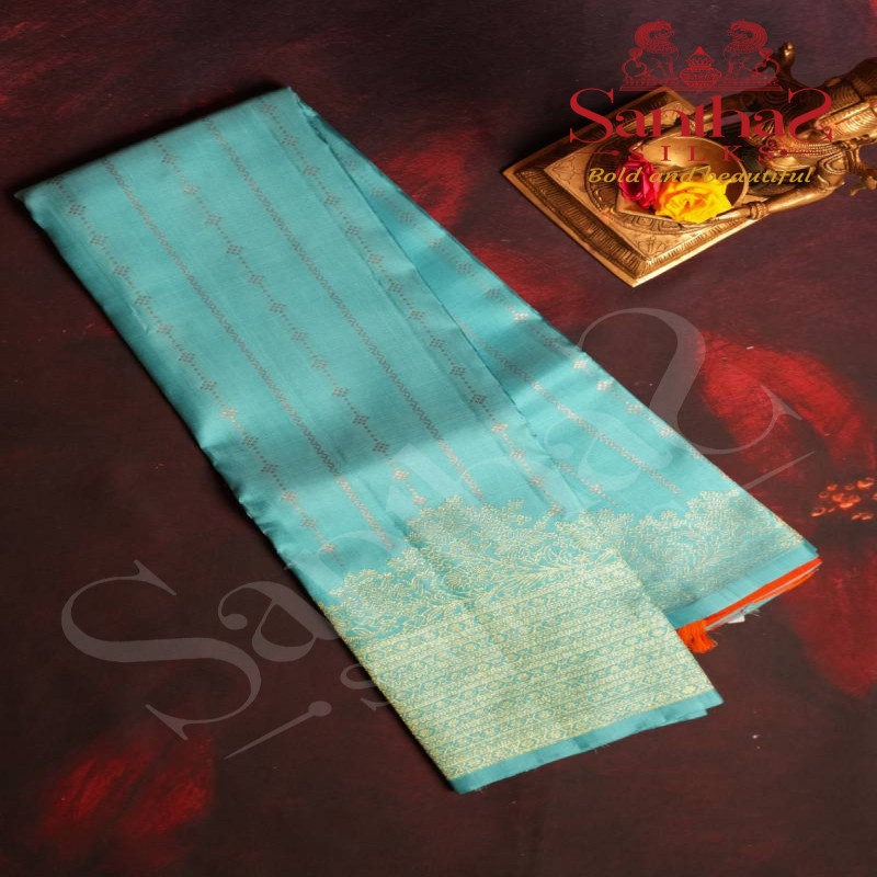 ICE BLUE COLOUR BODY WITH COPPER ZARI STRIPS AND ORANGE COLOUR CONTRAST BLOUSE