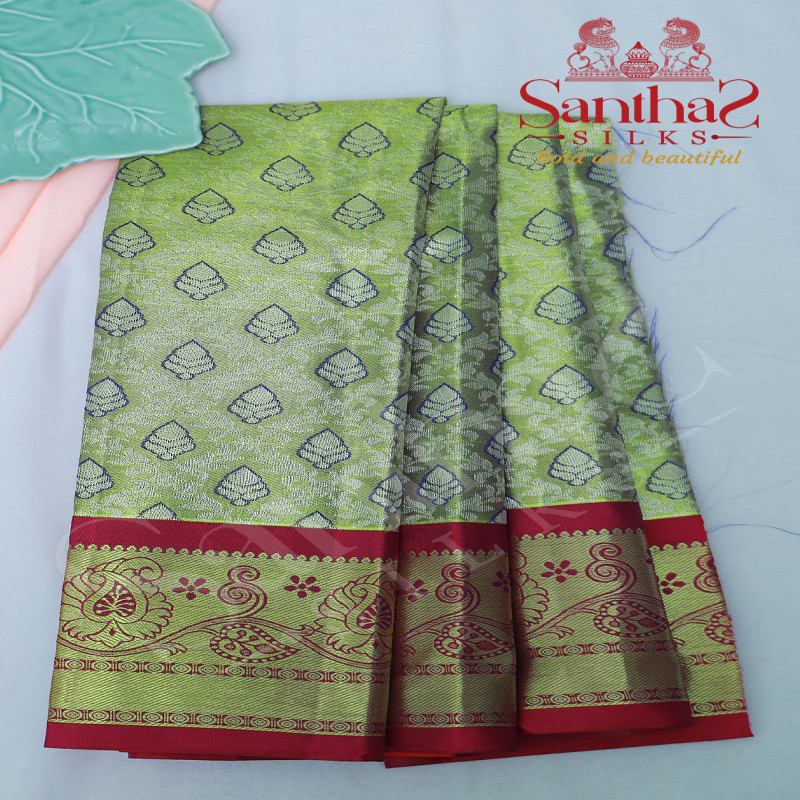 GREENISH GOLD TISSUE PATTUPAVADAI WITH CONTRAST BORDER AND BLOUSE