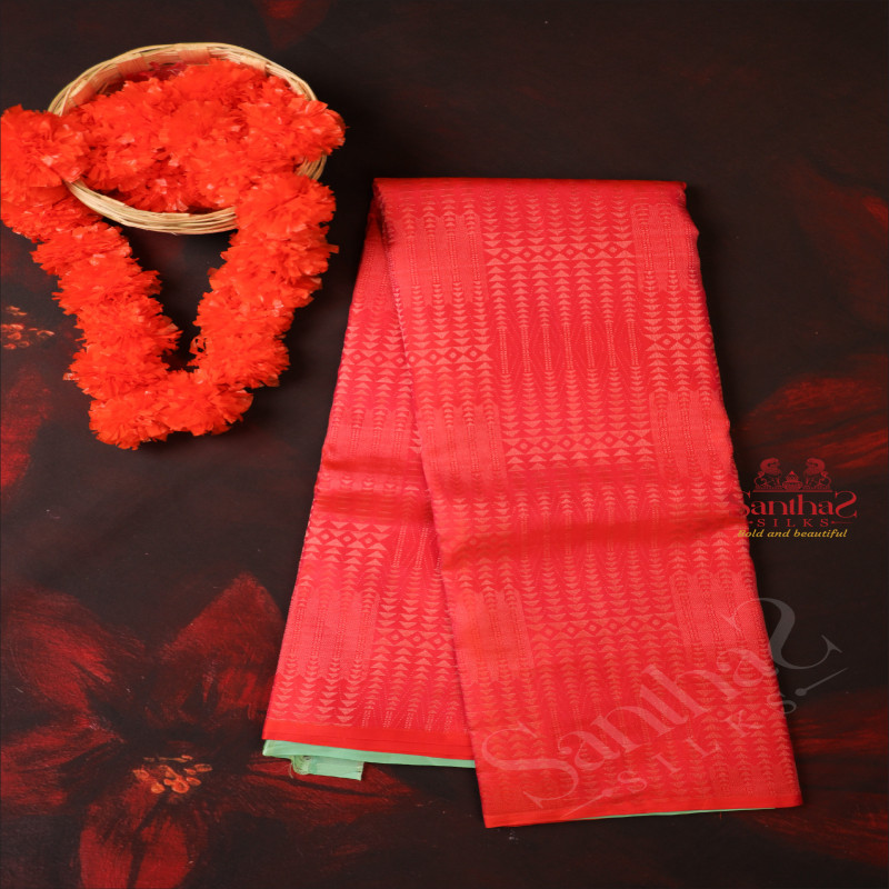 BORDERLESS RED ORANGE COLOUR BODY WITH ALL OVER BUTTA WITH CONTRAST BLOUSE