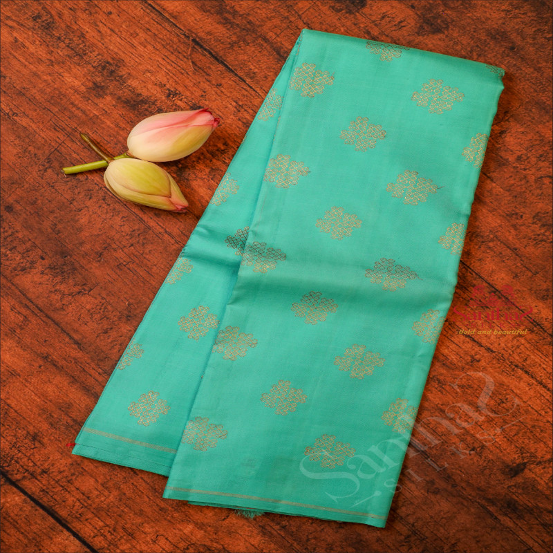 TORQUOISE BLUE COLOUR BODY WITH GOLDEN ZARI KOLAM BUTTA WITH CONTRAST BLOUSE