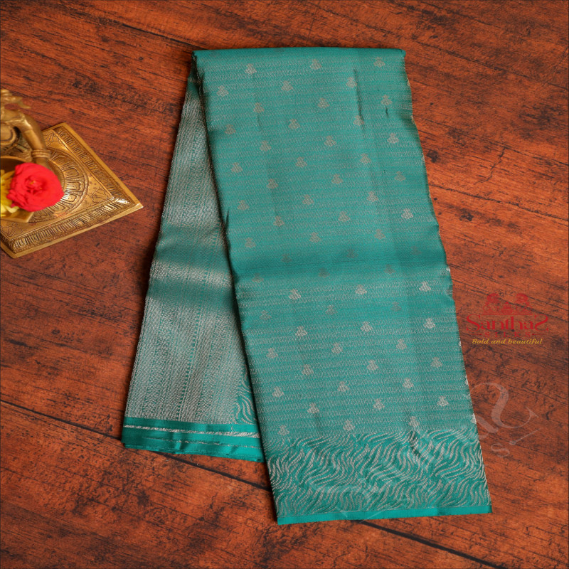 BORDERLESS DARK TEAL BLUE COLOUR BODY WITH ZARI EMBOSED WITH SELF BLOUSE