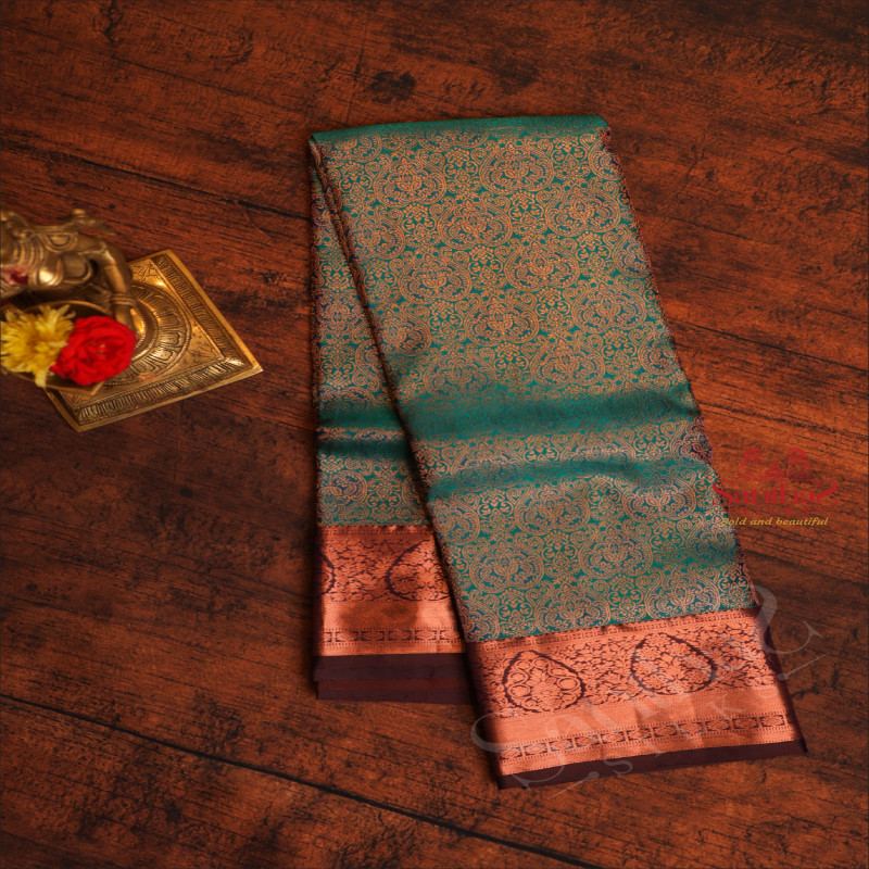 PEACOCK BLUE COLOUR BODY WITH JACQUARD FLORAL EMBOSED WITH CONTRAST BLOUSE & BORDER