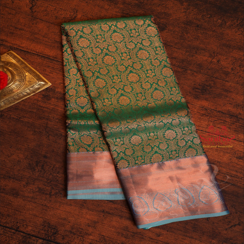 DARK GREEN COLOUR BODY WITH JACQUARD FLORAL EMBOSED IN COPPER ZARI WITH CONTRAST BLOUSE & BLUE BORDER