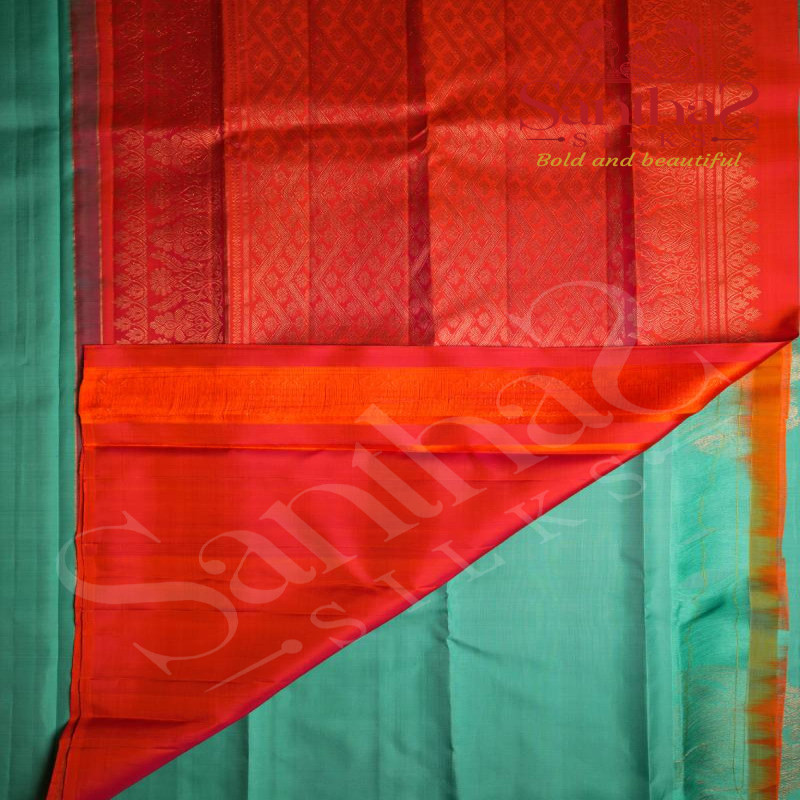 BORDERLESS AQUA BLUE COLOUR BODY WITH BIG MOTIFS AND ORANGISH RED COLOUR CONTRAST BLOUSE