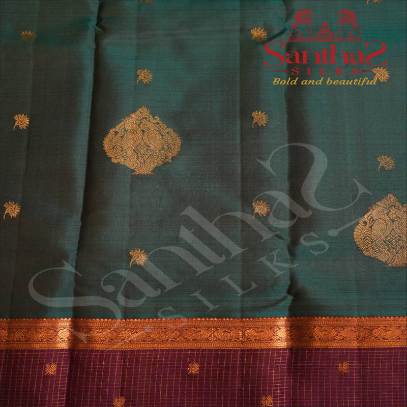 PEACOCK BLUE COLOUR BODY WITH GOLDEN ZARI FLOWER BUTTAS AND PURPLE COLOUR CONTRAST BLOUSE